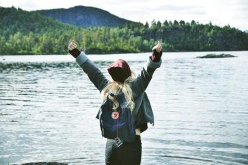 Young person putting arms in the air