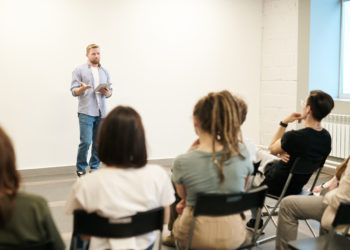 Teacher standing in front of students in classroom